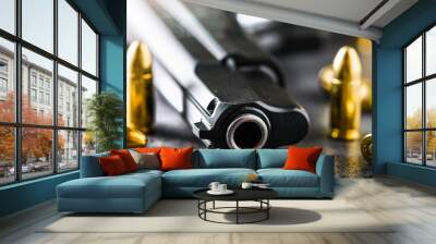 Hand gun detail with ammunition on stone table banner or panorama photo. 9 mm pistol gun weapon and bullets at dark background. Wall mural