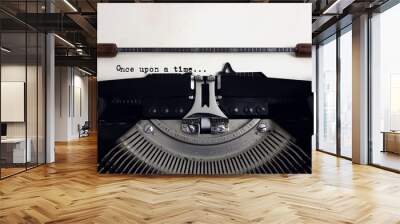 Old retro vintage black typewriter with close-up typing text Once upon a time as heading on aged paper Wall mural