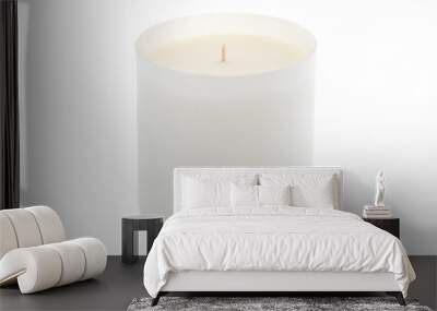 White scented candle in frosted glass laid on white background Wall mural