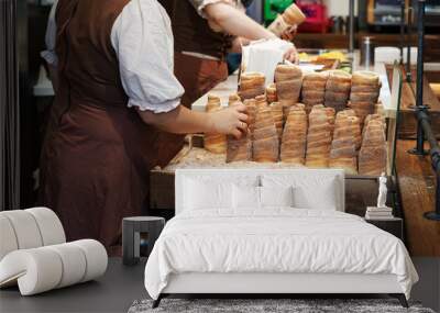 Making of Trdelnik cake, traditional Czech cinnamon pastry Wall mural