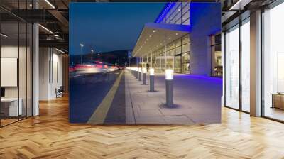 a row of column lighting in front the modern building at night Wall mural