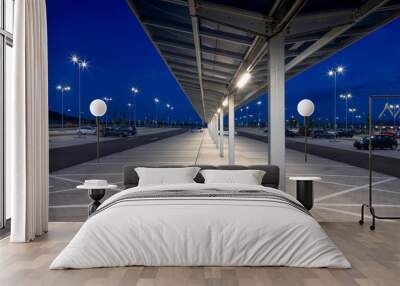 covered corridor for pedestrian in a modern parking lot at night with bright illumination Wall mural