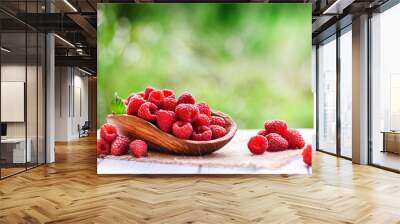 Ripe fresh raspberry in wooden rustic bowl on table. Wall mural