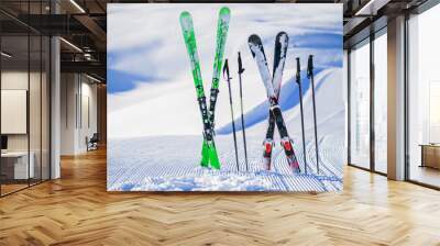 Skis in snow in winter season, mountains and ski items or equipments on the top in dolomites, Wall mural