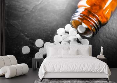 White medical pills or tablets with bottle on black background. Macro side view with copy space Wall mural