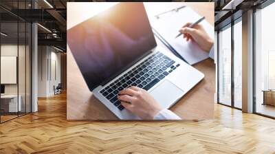 Woman working on modern computer top view. Laptop black screen and keyboard detail or close up with beautiful hands. Wall mural