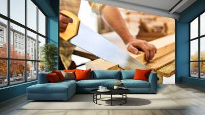 Worker hands use a wood cutter or saw on wooden board. Carpenter work in action. Wall mural