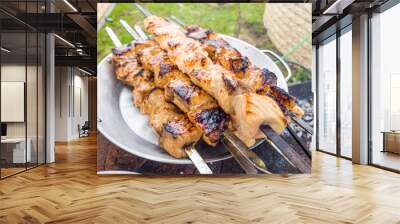 Grilled salmon fish kebab skewers on wooden board. Dark wooden background. Wall mural