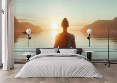 International Yoga Day background with a scene of a person sitting in a yoga pose on the beach at sunset. Wall mural