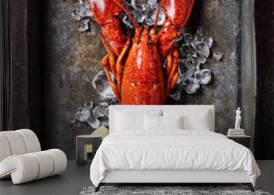 Lobster in a dark grey rusty tray served on ice with lemon and live, top view, vintage style Wall mural