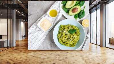 Cooked green spinach tagliatelle pasta on a plate with Parmesan cheese and avocado sauce, Italy food, healthy concept, vegetarian Wall mural