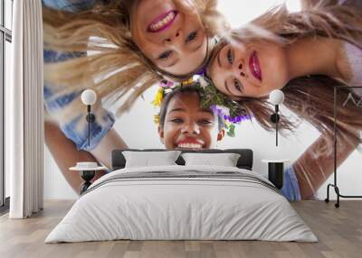 Group of cute young women of different ethnics hugging in a circle and smiling at camera  Wall mural