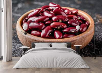 Red kidney beans in wooden bowl on dark rustic background. Wall mural