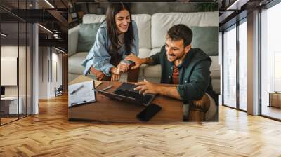 Adult couple girlfriend and boyfriend work from home on laptop Wall mural