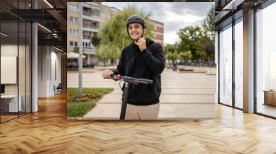 caucasian man drive or ride electric kick scooter e-scooter Wall mural