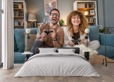 couple man and woman husband wife play console video games at home Wall mural