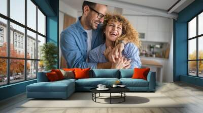 Happy adult caucasian couple at home husband and wife family concept Wall mural