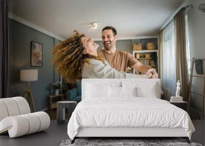 Happy couple adult caucasian man woman husband and wife dance at home Wall mural