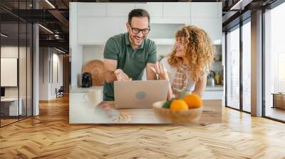 happy couple man and woman husband and wife morning routine use laptop Wall mural