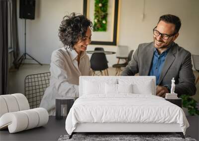 Mature woman sign insurance or contract to adult man in cafe Wall mural