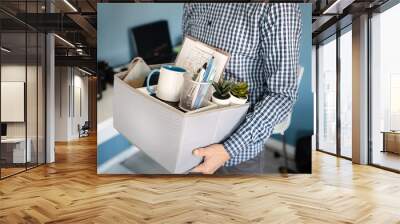 Midsection close up of unknown caucasian man holding a box with personal items stuff leaving the office after being fired from work due recession economic crisis downturn losing job company shutdown Wall mural