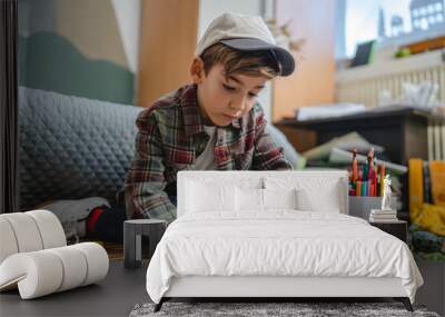 one small caucasian boy Gradeschooler child draw with crayon at home Wall mural