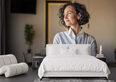 One woman mature caucasian female businesswoman entrepreneur stand at work or home real people copy space wear white shirt curly hair Wall mural