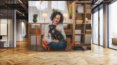 portrait of adult caucasian woman mature female with pet dog at home Wall mural