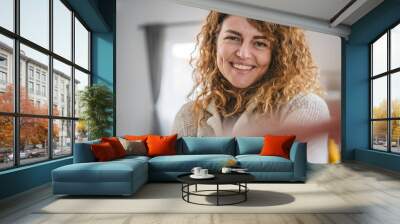 Portrait of adult caucasian woman with curly hair at home happy smile Wall mural