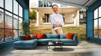 Portrait of japanese business woman stan in front the modern buildings Wall mural