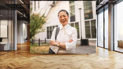 Portrait of japanese business woman stand in front buildings Wall mural