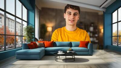 Portrait of young caucasian teen male young man stand at home Wall mural