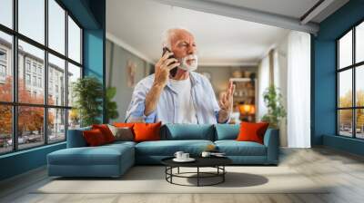 Senior man sit at home have a phone call while receive bad report Wall mural