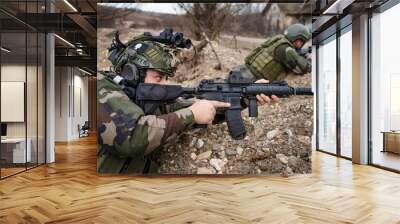 Two men soldiers holding position in the battle war zone aiming rifles dogs of war professional mercenaries or volunteers special forces on a mission attacking or defending enemy copy space Wall mural