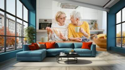 two women senior mature knitting and embroidery during leisure time Wall mural