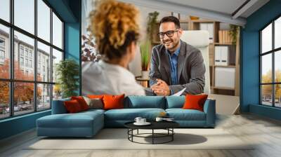 Woman on interview for a job with her biography CV at office Wall mural