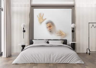 Screaming male face with hands pressed against window from a foggy background Wall mural