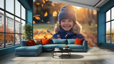 Joyful boy child having fun outdoors in the park in autumn time. Kid on yellow fall season leaves background Wall mural