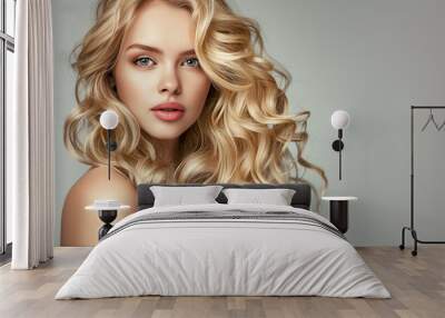 Perfect curly hairstyle woman. Blonde fashion model with wavy long hairdo portrait. Volume, coiffure, cosmetic, hair care and hair treatment concept Wall mural