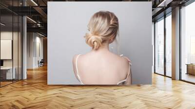 Beautiful blonde hairstyle, female back and head on white background Wall mural