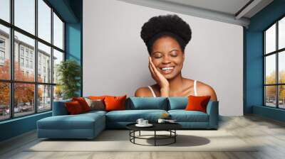 beautiful smiling young woman with perfect skin touching her face with her hands, attractive female  Wall mural