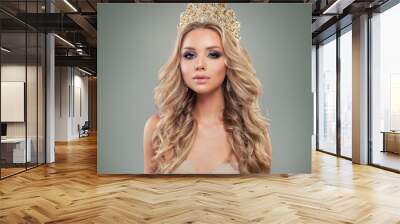 Blonde woman with makeup, long curly hairstyle, gold jewelry crown, fashion portrait Wall mural