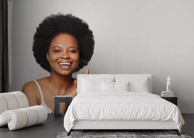 Cheerful perfect excited surprised happy young woman posing on white studio wall background Wall mural