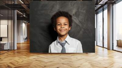 Happy black kid boy. Cute child on blackboard background portrait Wall mural