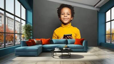 Happy smiling black child boy with smartphone Wall mural