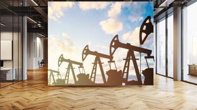 oil pump jack. oil industry equipment silhouette against blue sky clouds background Wall mural