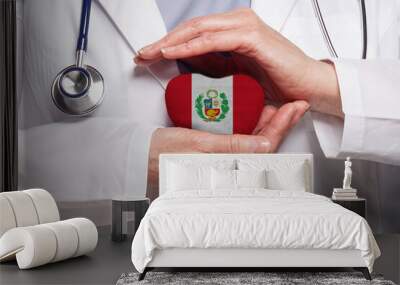 Peruvian doctor holding heart with flag of Peru background. Healthcare, charity, insurance and medicine concept Wall mural