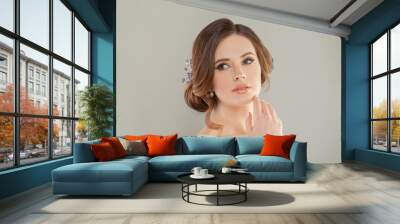 Portrait of a cheerful beautiful young woman with natural fresh makeup and hairstyle Wall mural