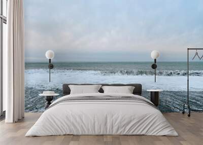 Sea background. Sea wave, empty beach and grey sky Wall mural