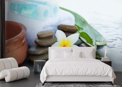 Two bottles with oil for massage. Spa concept with flowers and leaves Wall mural